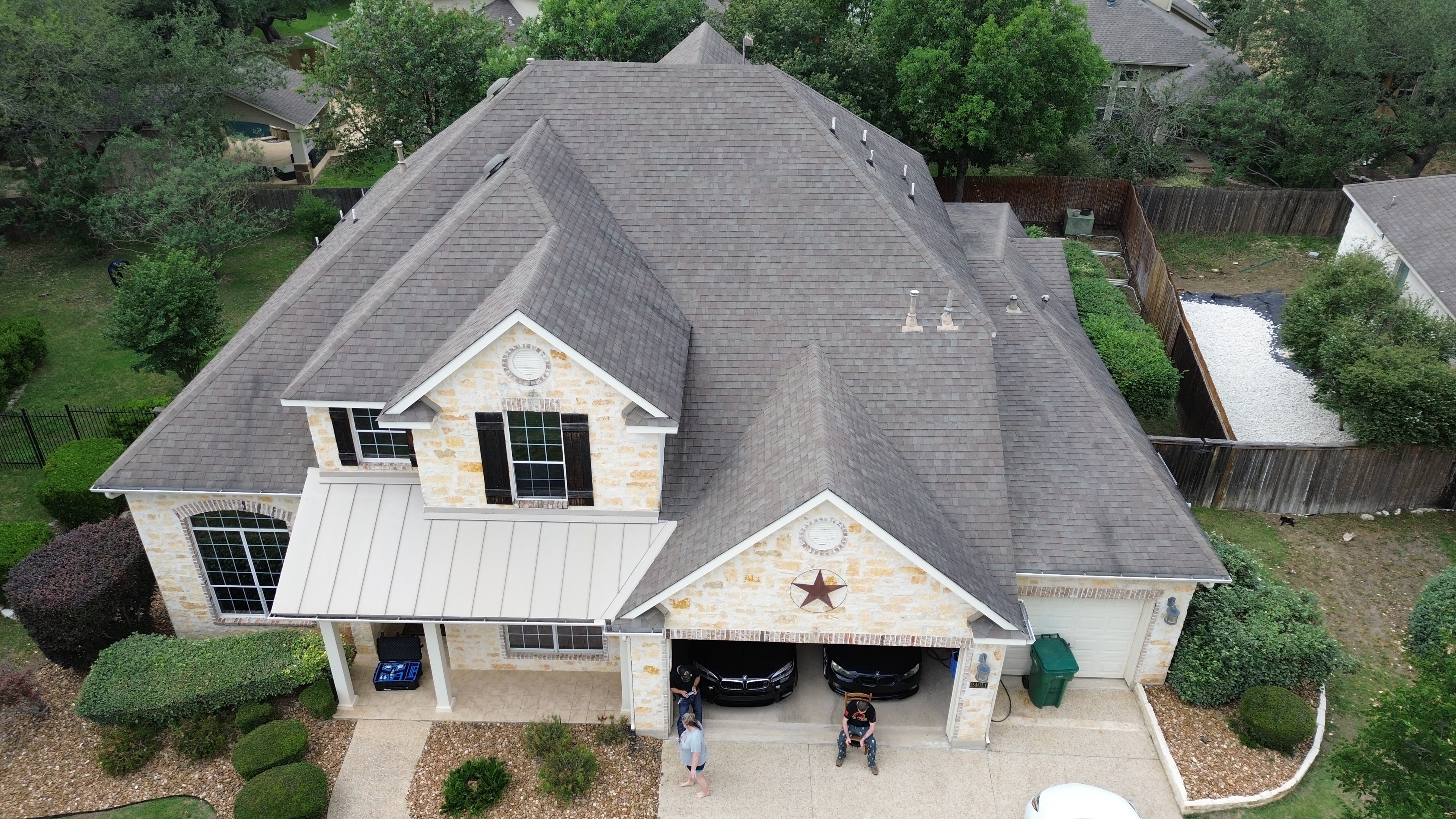 Aerial view suburban home with garage