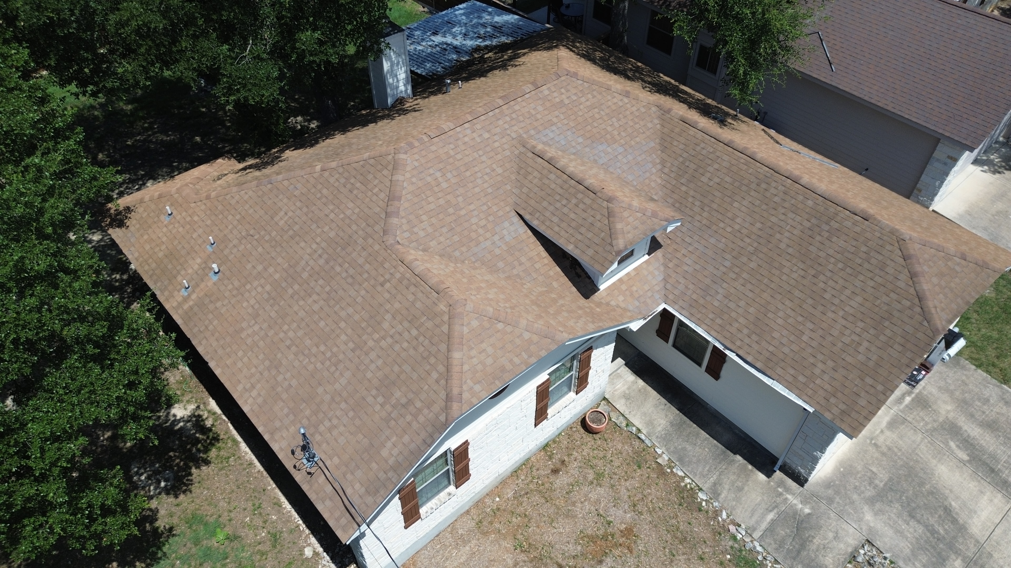 Aerial view brown shingled roof vents