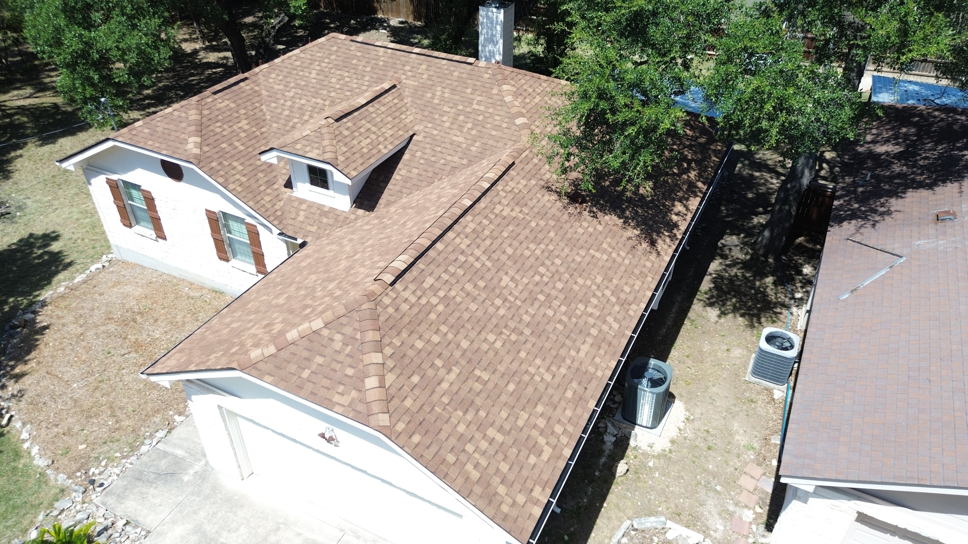 Aerial view completed brown shingle roof