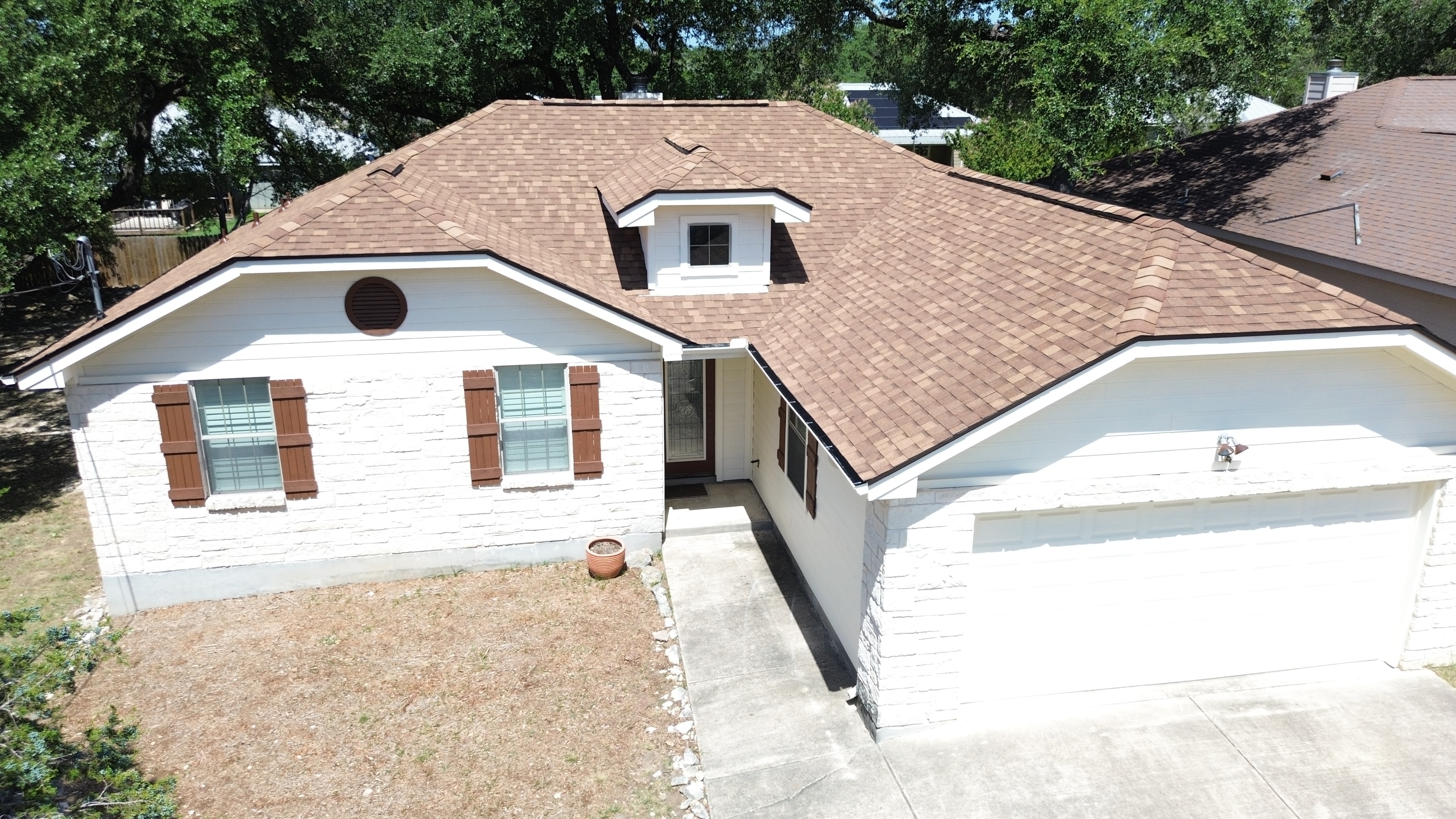 Street-level view completed roof and garage