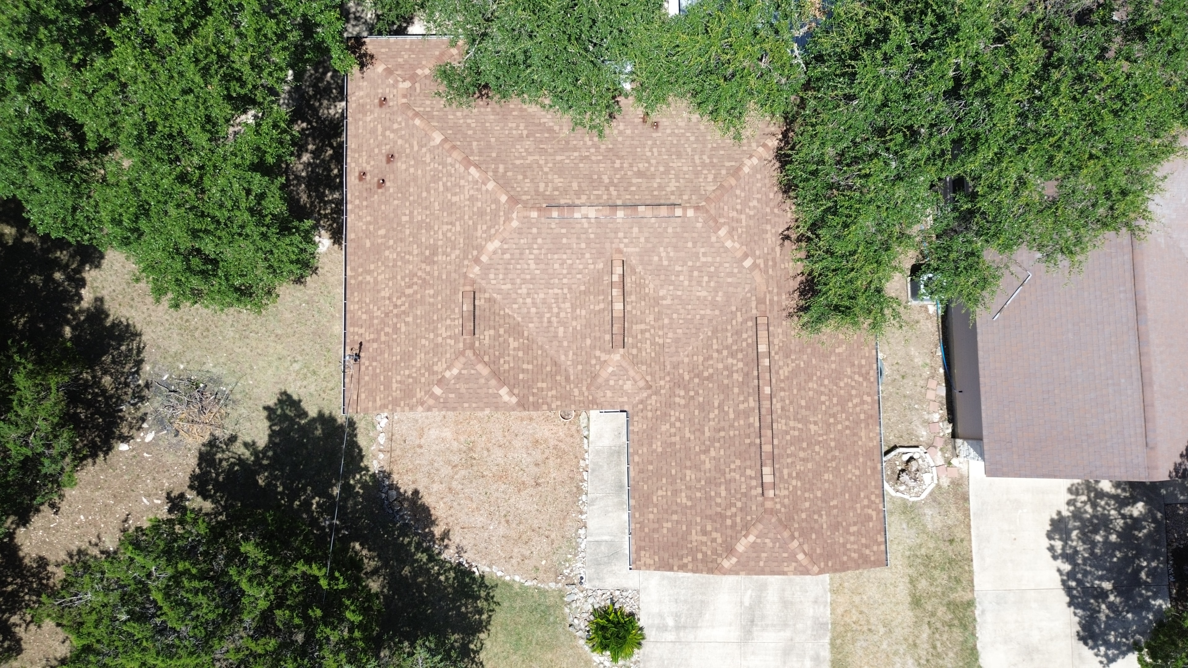 Aerial view completed roof surrounded by trees