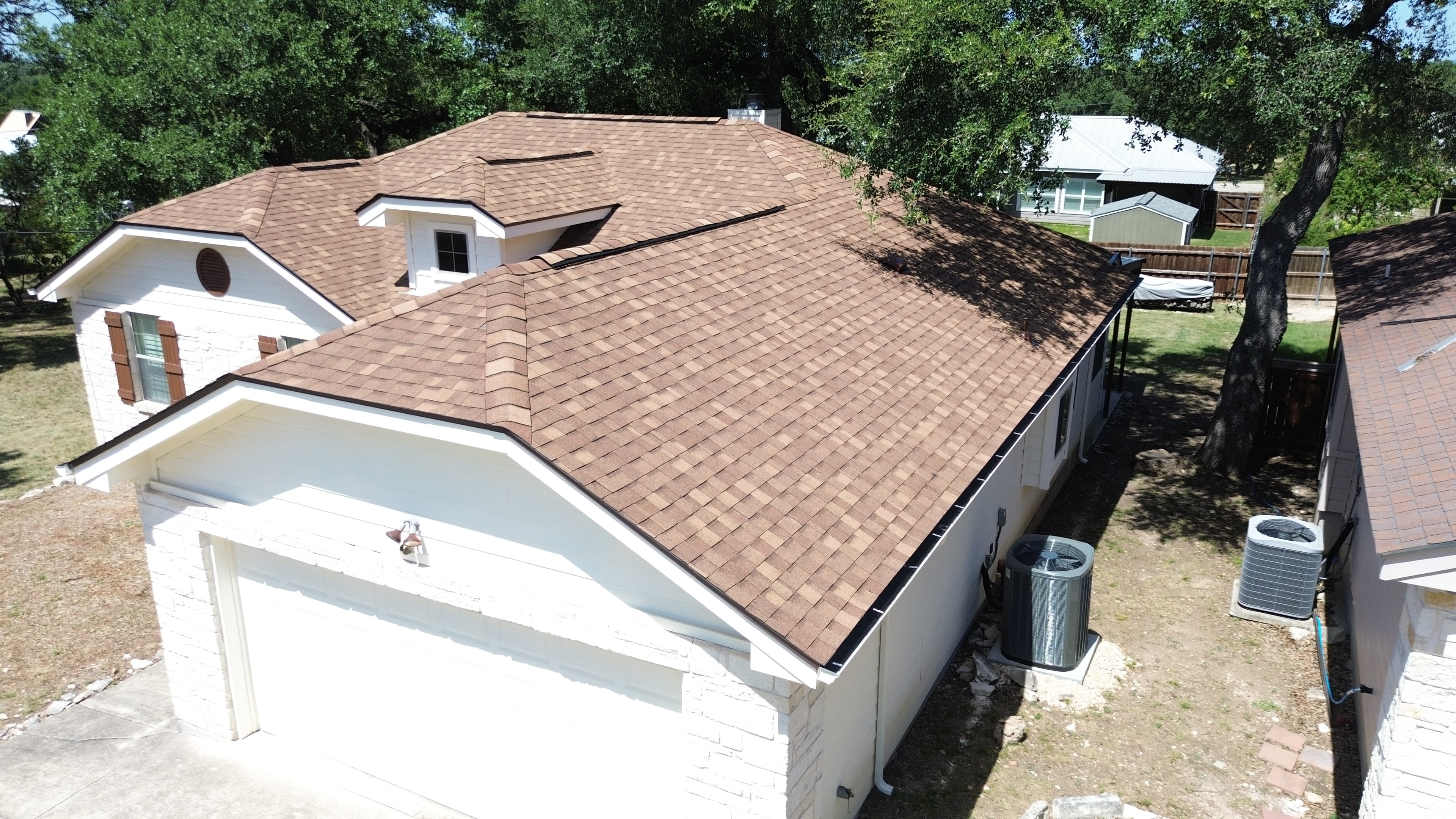 Aerial view completed roof with trees
